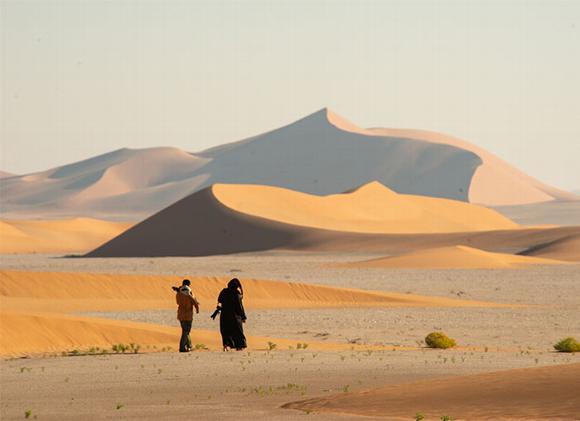 two people standing in desert